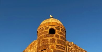 a tall brick tower with a sky background