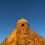 a tall brick tower with a sky background