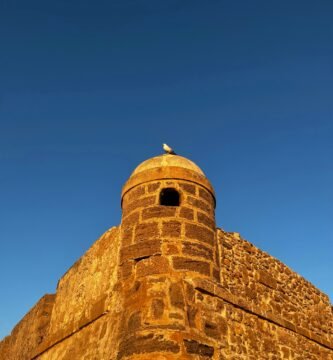 a tall brick tower with a sky background